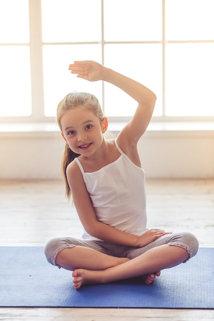 Charming little girl is looking at camera and smiling.