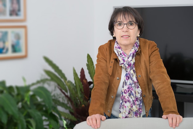 Charming mature woman with brown jacket and glasses