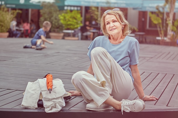 Charming pensioner has  rest outdoor.