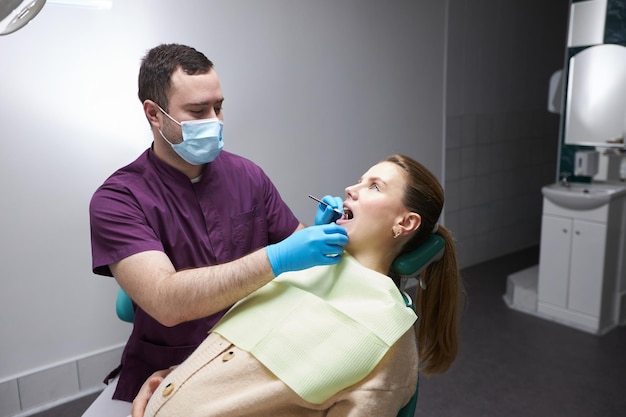 Charming pregnant woman at regular medical checkup in dentist office Oral and dental care concept