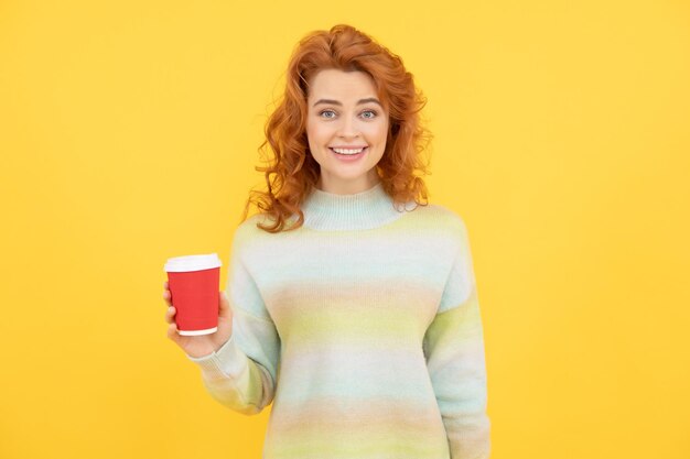 Photo charming redhead woman face portrait drink coffee from paper cup on yellow background, good morning.