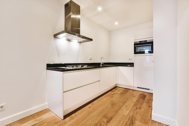 A charming room with a kitchen area with a black countertop