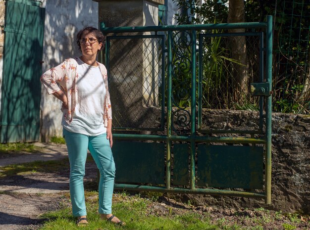 Charming senior woman standing in the park