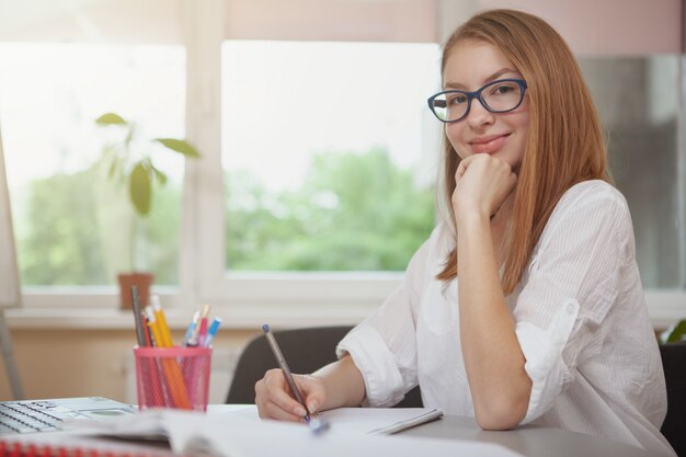 Charming teenage girl studying before exams