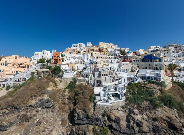 Charming view oia village on santorini island greece traditional famous blue dome church over the caldera in aegean sea traditional blue and white cyclades architecture