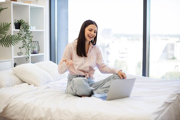 Charming woman enjoying online conversation with friends