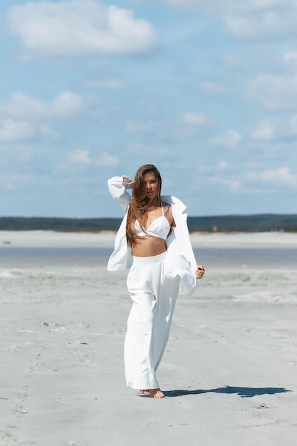 Charming woman standing on beach