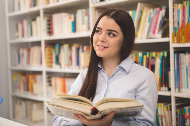 Charming woman studying at the library