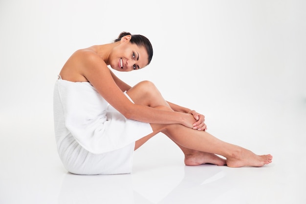 Charming woman in towel sitting on the floor