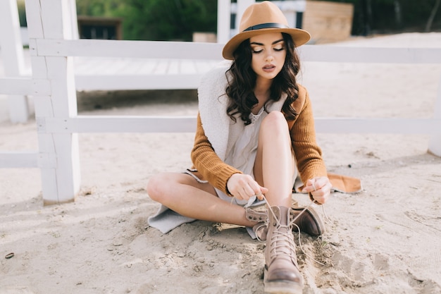 Charming woman tying shoelaces