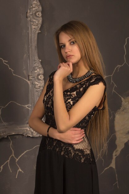 Charming woman with blonde hair dressed in lace dress.Studio shot