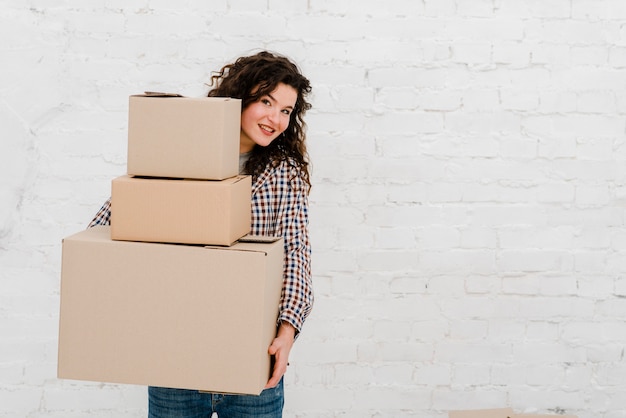 Charming woman with stack of boxes