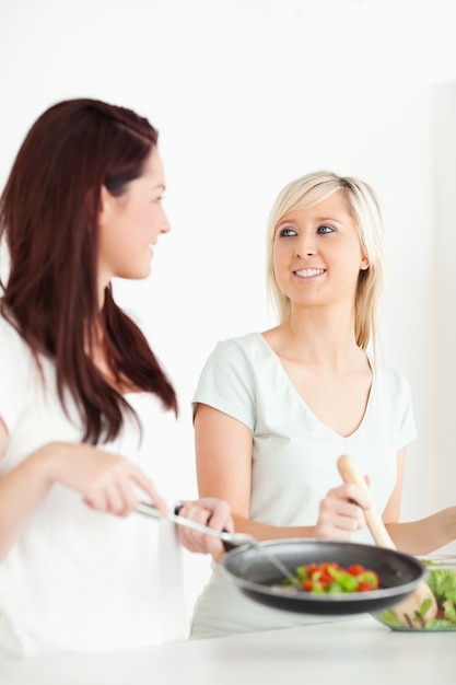 Charming Women cooking dinner