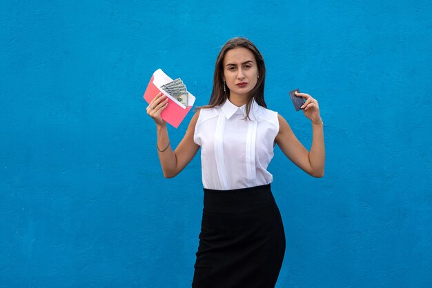 Charming young business lady holding dollars