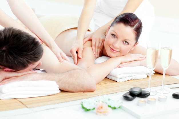 Charming young couple enjoying a back massage