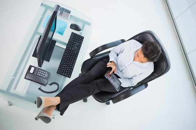 Charming young dark haired businesswoman using a tablet pc