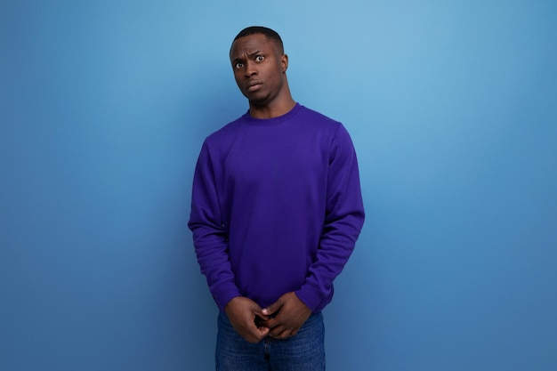 Charming young man living in america on a blue background with copy space