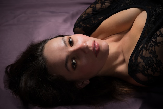 Charming young woman laying on the floor