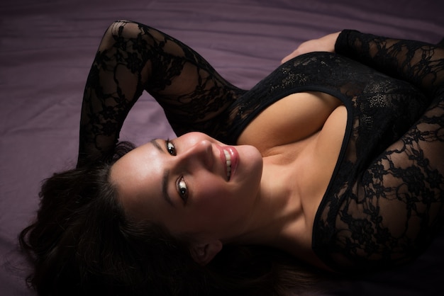 Charming young woman laying on the floor