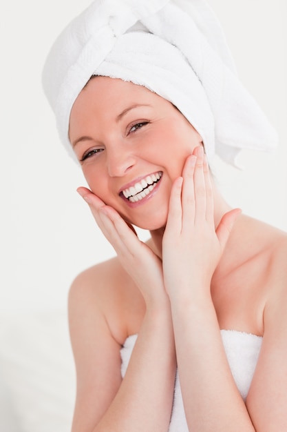 Charming young woman wrapped in a towel