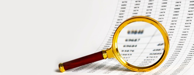 Chart and a magnifying glass on the table, the tools for the\
study of documents and space for text