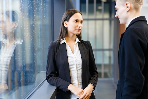 Chatting with Colleague in Office Lobby