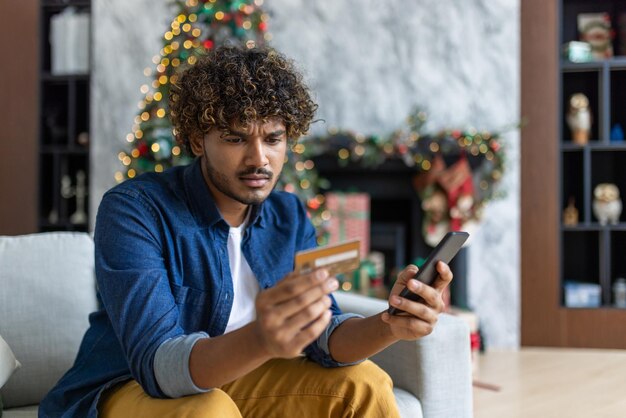 Cheated and upset christmas man in living room near decorated christmas tree rejected and wrong