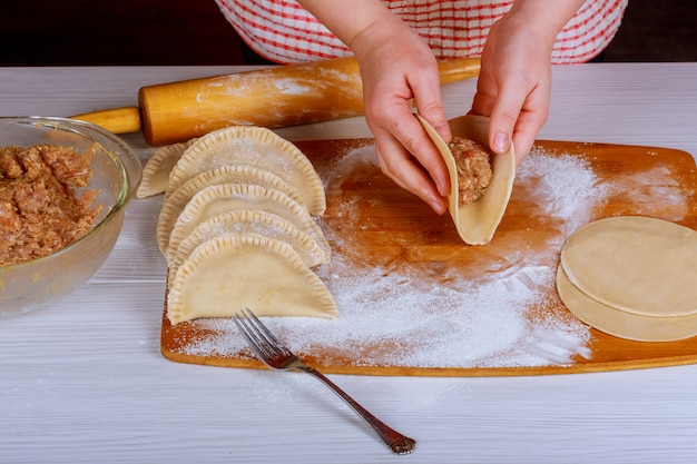 Chebureki with meat cooking in boiling oil. 