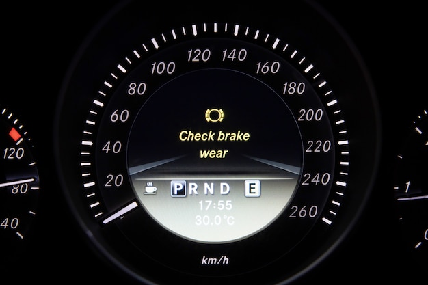 Photo check brake wear sign on car dashboard