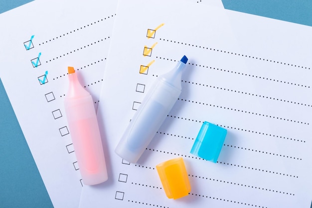 Photo check list with blue and orange marked points and markers on blue background