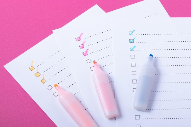 Photo check list with pink, blue and orange marked points and markers on pink background