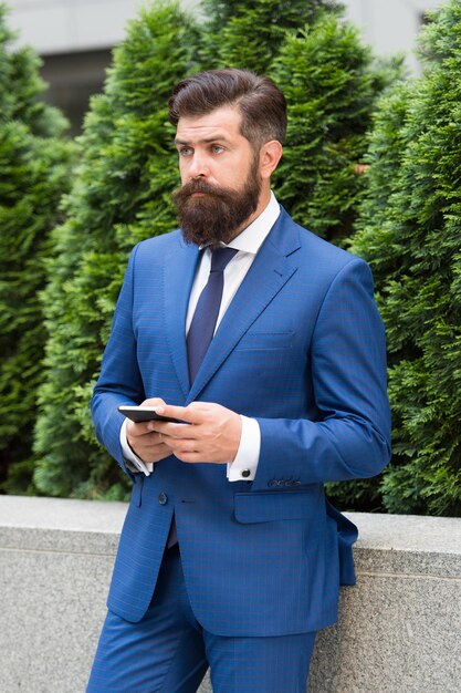 Check out updates SMS messaging business Bearded man texting sms Businessman send sms using smartphone Sms message Short message service Text messaging by mobile phone Mobile marketing