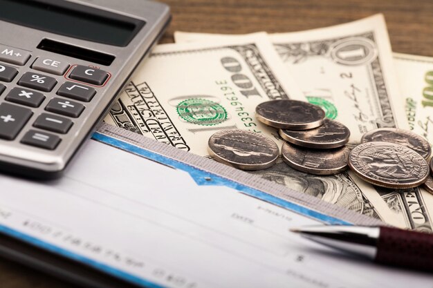 Checkbook, Pen, Calculator and Money - Close Up