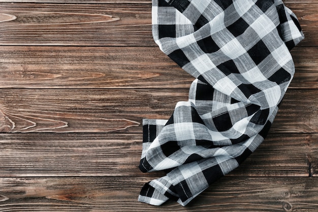 Checkered kitchen towel on wooden table