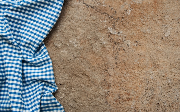 Checkered napkin on a stone surface