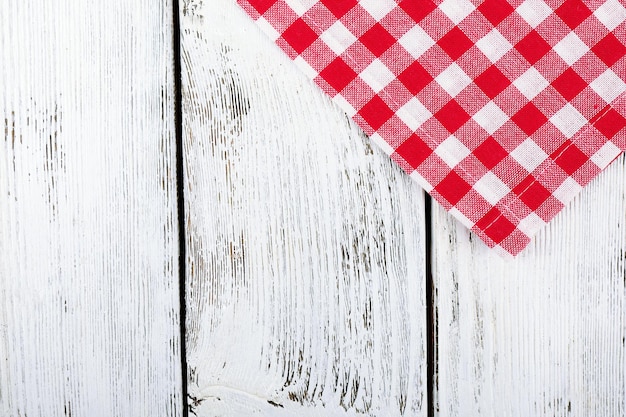 Checkered napkin on wooden table background