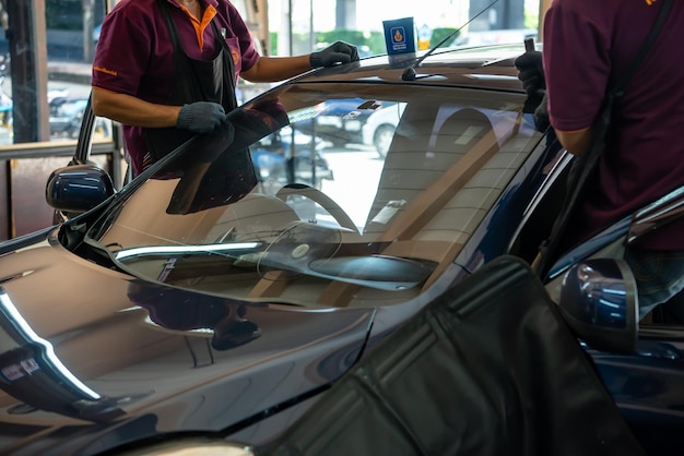 Checking car windscreen windshield at car garage