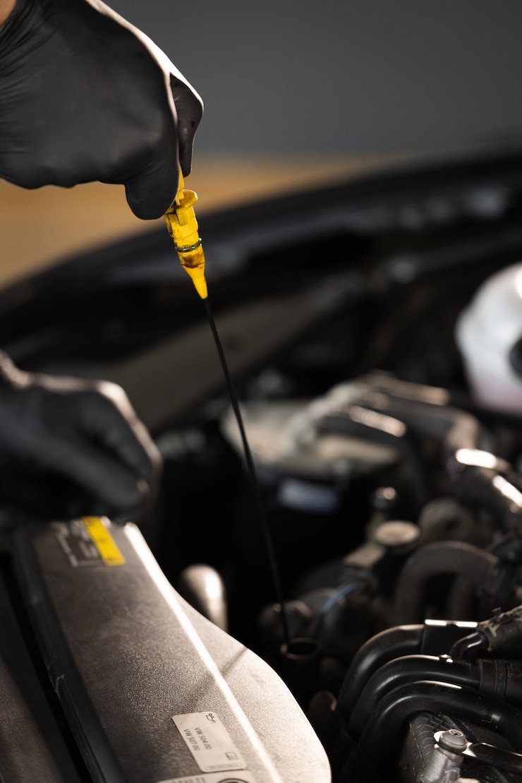 Photo checking the engine oil car maintenance remove the dipstick to view the engine oil level