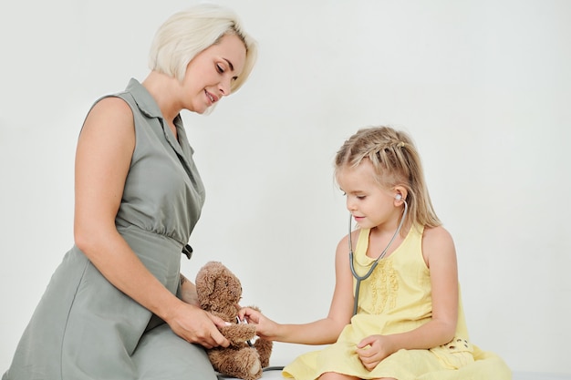 Checking heartbeat of teddy bear