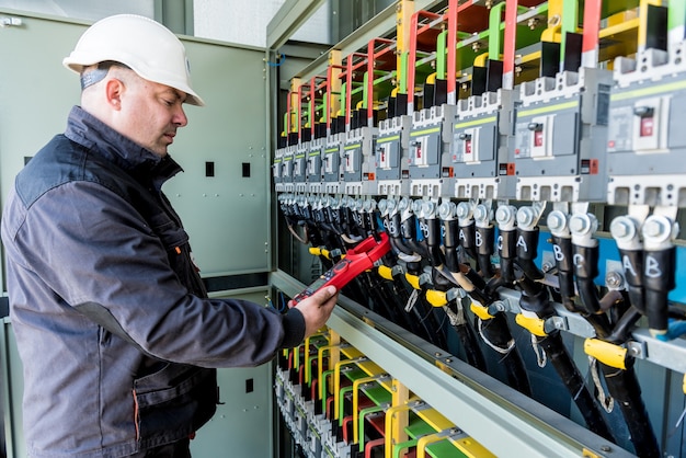 Checking the operating voltage levels of the solar panel switchgear compartment