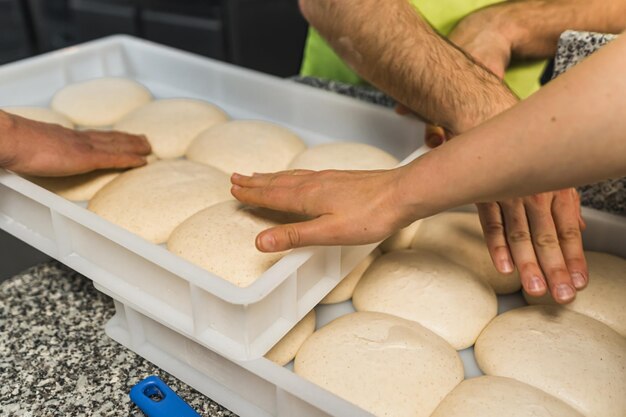 Checking pizza dough balls if they are ready process before baking pizza