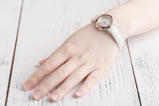 Checking time, female wrist watch on hand