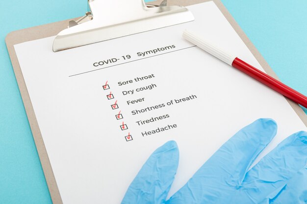 Checklist On Clipboard COVID-19 symptoms concept. Evaluation list Covid outbreak