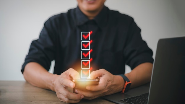 Photo checklist concept businessman checking mark on the check boxes with marker red