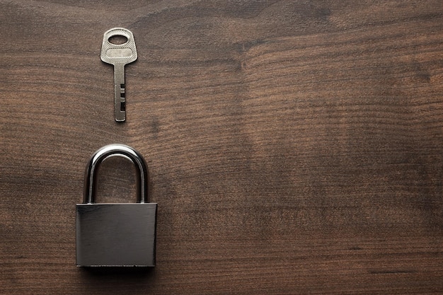 Checklock and key on the brown wooden table