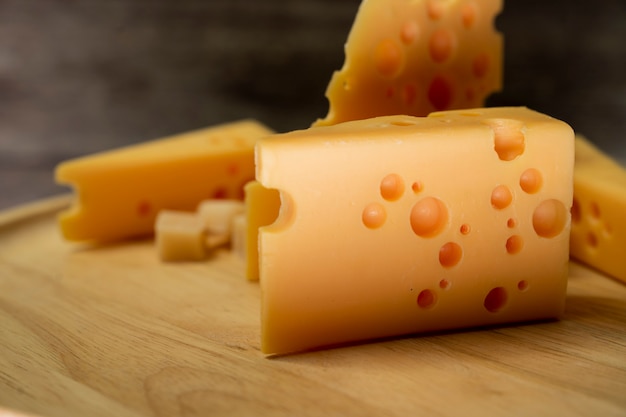 cheddar cheese slice on wood plate