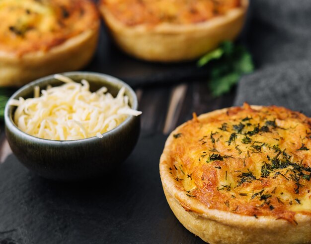 Cheddar cheese and spring onion omelette tarts served on wooden board