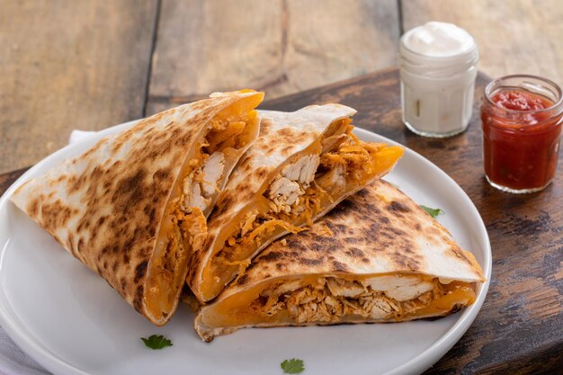 Cheddar and chicken quesadillas cut into slices on a plate