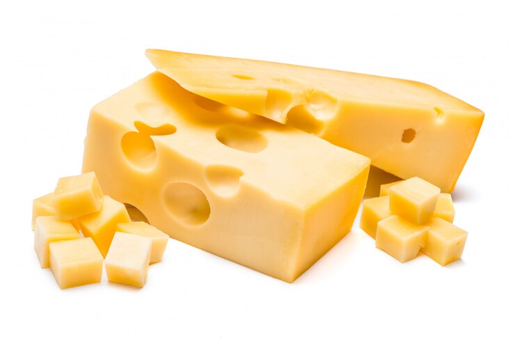 Foto cheddarkaas op witte muur