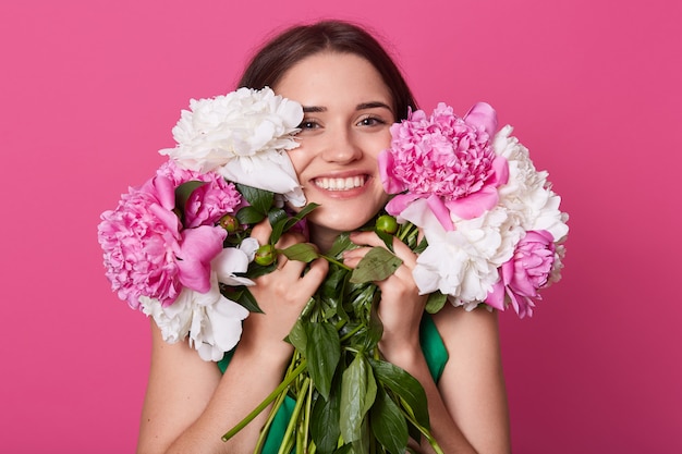 Cheerful active young female looking directly at camera